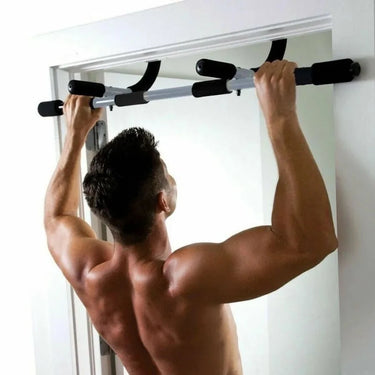 Man using door frame pull-up bar